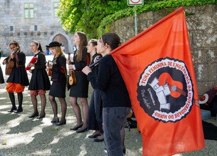 Group female university students musicians perform in street, city of Guimaraes, northern Portugal