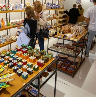 Shopping inside tourist souvenir craft shop selling pottery and ceramics, Guimaraes, northern