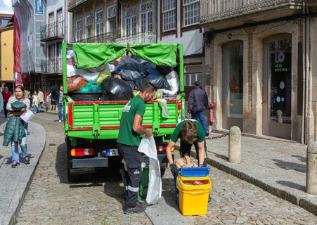 Waste refuse collection service in city centre street, Guimaraes, northern Portugal
