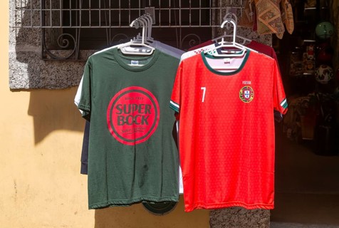 Super Bock brand t-shirt and replica national football shirt on display outside shop, Guimaraes,