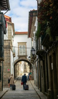 Narrow medieval street Rua de Santa Maria, city centre of Guimaraes, northern Portugal