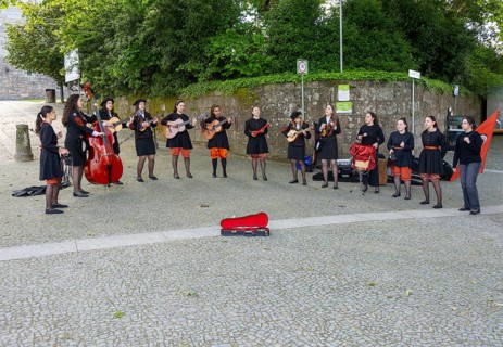 Group female university students musicians perform in street, city of Guimaraes, northern Portugal
