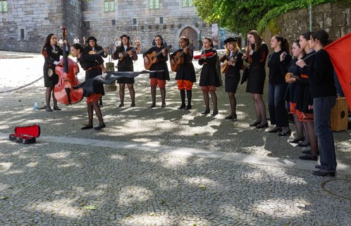 Group female university students musicians perform in street, city of Guimaraes, northern Portugal