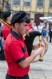 Traditional piper in band performing on city streets on May Day 2025, Guimaraes, Braga district,