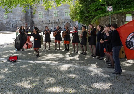 Group female university students musicians perform in street, city of Guimaraes, northern Portugal