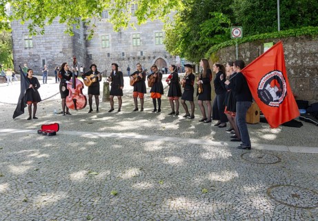 Group female university students musicians perform in street, city of Guimaraes, northern Portugal