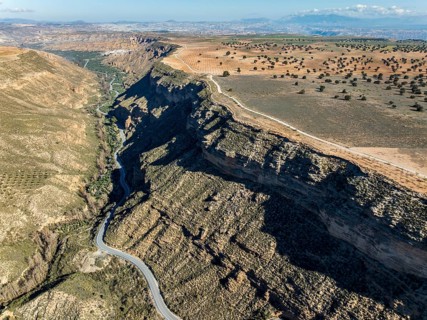 Deep canyon at the Gorafe desert, winding road to village Gorafe, aerial view, Gorafe Desert,