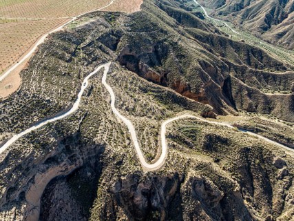 Canyons and gorges near village Gorafe, winding road, aerial view, Gorafe Desert, UNESCO Granada
