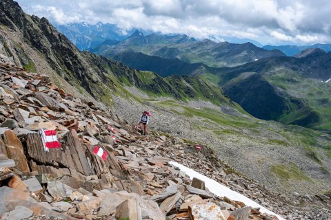 Red and white trail markings, hiker in the high mountains, Lasörling High Trail, Lasörling High