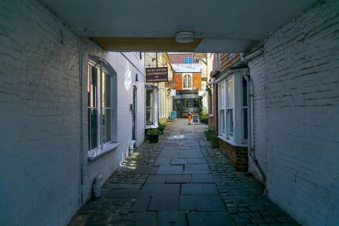 Specialist shops in Old Hughenden Yard alleyway, Marlborough, Wiltshire, England, UK