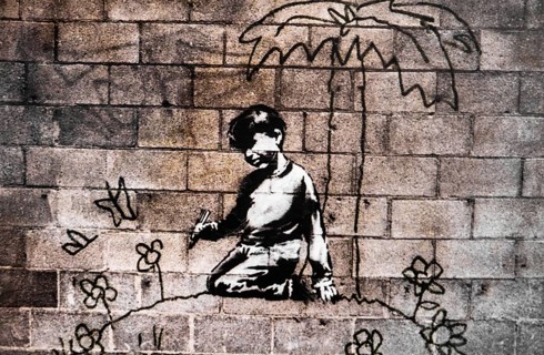 Banksy - Child paints himself a world of flowers, exhibition The World of Banksy