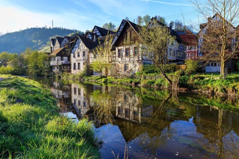 Historic half-timbered houses are reflected in the Kinzig, old town centre of Schiltach, Black