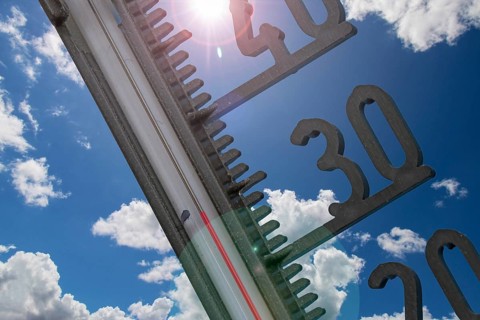 (Photomontage) Symbolic image of heat: thermometer in front of a summer sky