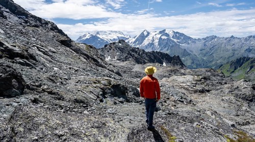 Mountaineer in rocky mountain landscape at the Col du Louvie, view of the summit of the Grand