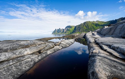 Reflection in a tidal pool, rocky coast of Tungeneset, Devil's Teeth, Okshornan, Ersfjorden, Senja