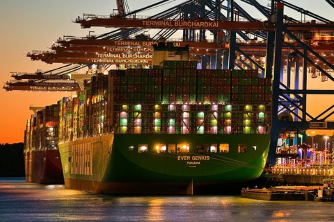 Container terminal Burchardkai with full container ship Ever Genius from Panama in the evening,
