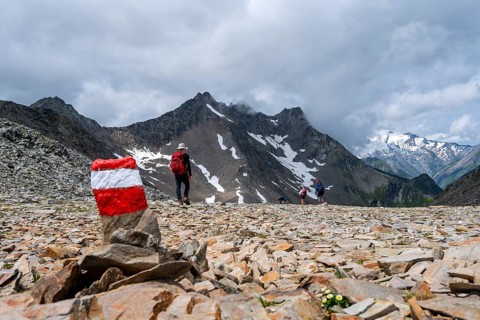 Red and white trail markings, hiker in the high mountains, Lasörling High Trail, Lasörling High