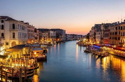 View of the Grand Canal at the blue hour, picturesque evening mood with illuminated palazzos on the