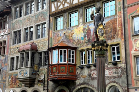 Soldier figure on the market fountain, house facade with facade painting in the old town, Stein am