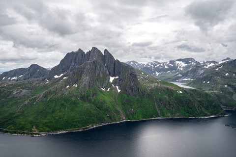 View of Mefjorden fjord from Barden mountain, Breidtind mountain peak behind, Senja, Norway, Europe