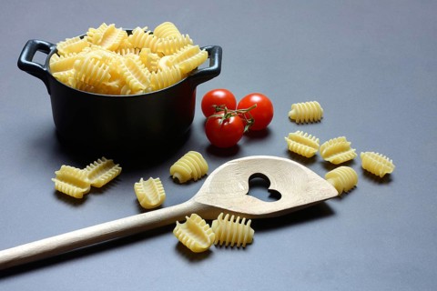 Cooking spoon with heart and Italian pasta, Radiatori variety