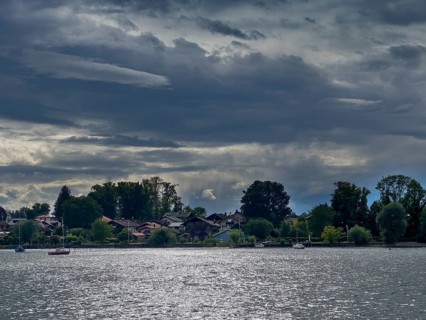 Dark clouds over Lake Chiemsee, view of the island of Frauenchiemsee, Bavaria, Germany, Europe