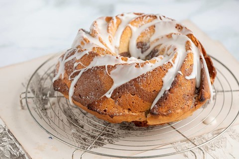 Marble bundt cake, cake with icing on a cake rack, light background