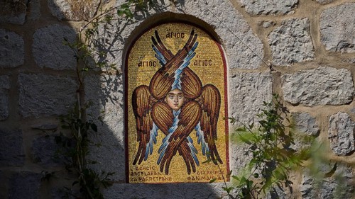 Detailed view of a mosaic with a winged saint on a stone wall, woman's monastery, Evangelismou