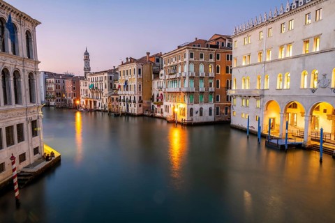 View of the Grand Canal at sunset, picturesque evening mood with illuminated palazzos on the canal