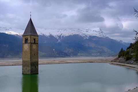 Bad weather at the church tower of Altgraun in Reschensee, Reschenpass, Vinschgau, South Tyrol,