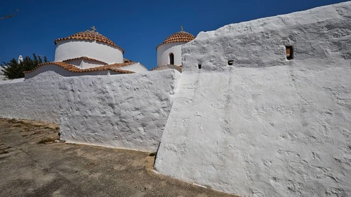 Church of Agia Kioura, White, rustic monastery building with domes under a clear sky, Church,