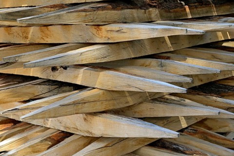 Stacked fence posts with sharpened ends. North Rhine-Westphalia, Germany, Europe