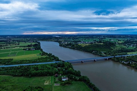 Twilight over bridge and filekds in Libourne from a drone, Gironde, Nouvelle-Aquitaine,