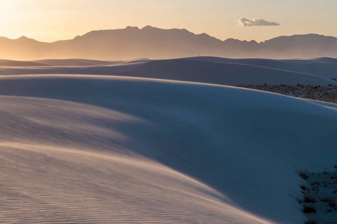 Smooth curved sand dunes in evening light at White Sands National Park in Alamogordo, New Mexico,