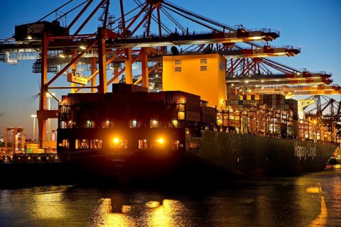 Container ships at the Eurogate container terminal in the evening with an atmospheric sunset,