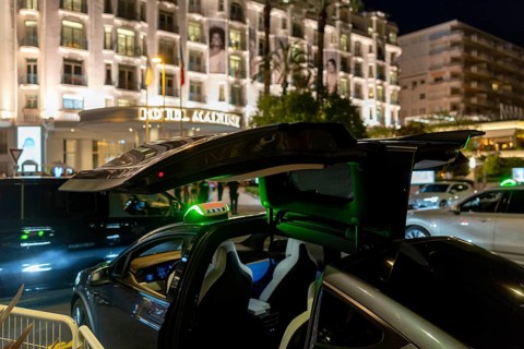Cannes, France - 23 May 2024: A Tesla taxi stands in front of a hotel on the Promenade de la