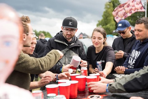 Festival visitors play a drinking game on a campsite at the Rock am Ring Festival on Saturday,