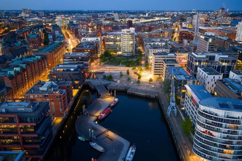 Aerial view of the Speicherstadt Hamburg with Magellan Terraces at Sandtor harbour at blue hour,
