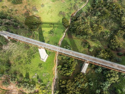 Cycle path Via Verde Del Aceite, old railroad track passes through olive fields, cycle path on