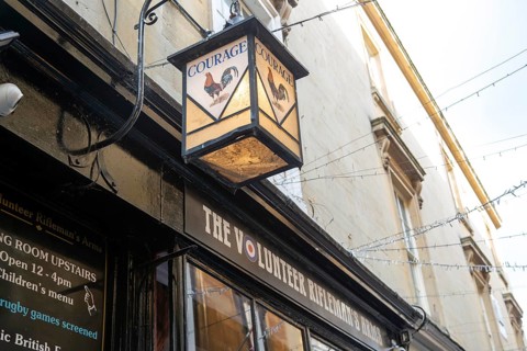 Vintage Courage pub lamp sign outside The Volunteer Rifleman's Arms pub, city of Bath, north east