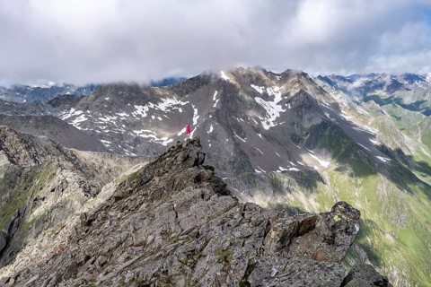 Hiker on a rock, Lasörling Höhenweg, Lasörling Group, Hohe Tauern National Park, East Tyrol, Tyrol,