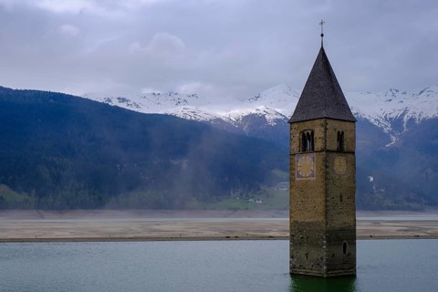 Bad weather at the church tower of Altgraun in Reschensee, Reschenpass, Vinschgau, South Tyrol,