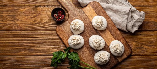 Raw freshly made Khinkali, traditional dish of Georgian Caucasian cuisine, dumplings filled with