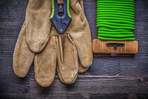 Garden shears soft wire tie protective gloves on vintage wooden board gardening concept