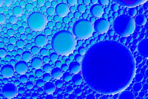 Colorful abstract macro background with oil drops in water