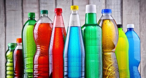 Plastic bottles of assorted carbonated soft drinks in variety of colors