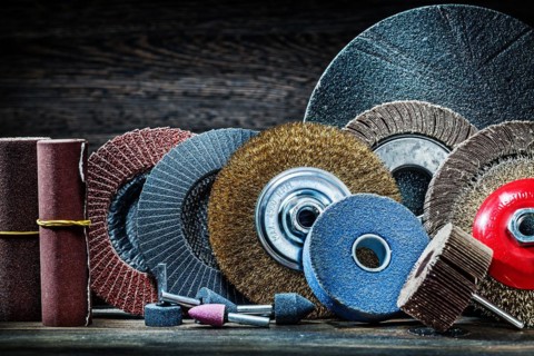 Large set of sanding tools on vintage wood background
