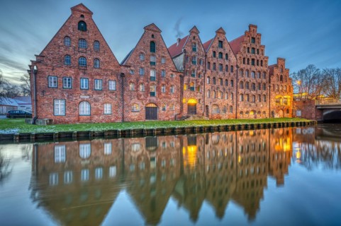 The historic salt warehouse with the river Trave at dawn, seen in Lübeck, Germany, Europe
