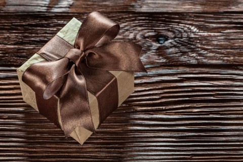 Brown gift box on vintage wooden board