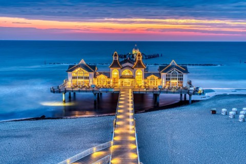 Pier with restaurant seen in front of sunrise on the island of Rügen, Germany, Europe